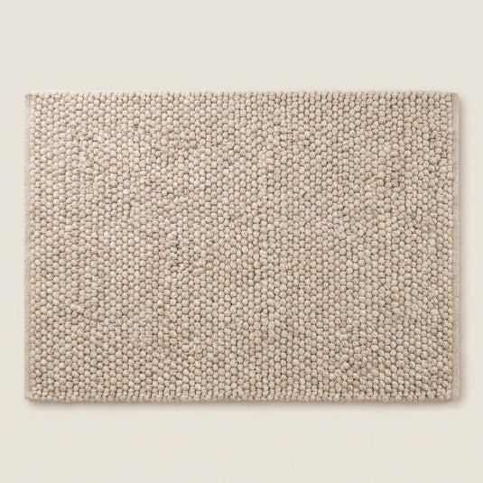 Translation missing: es.Top view of neutral chunky knit style rug with sculptural braided texture