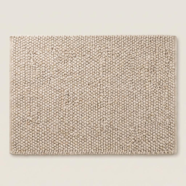 Translation missing: es.Top view of neutral chunky knit style rug with sculptural braided texture