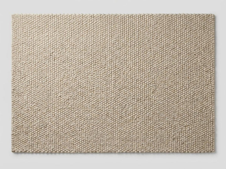 Translation missing: es.Top-down view of textured neutral wool rug with dense handcrafted surface