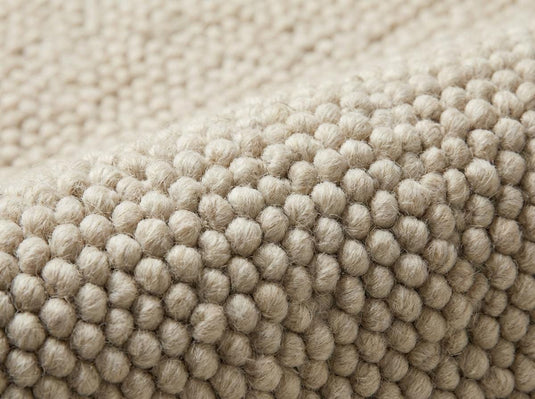 Translation missing: es.Detailed view of rounded loop texture on neutral woven area rug