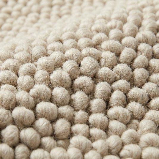 Translation missing: es.Close-up of dense looped texture on neutral area rug