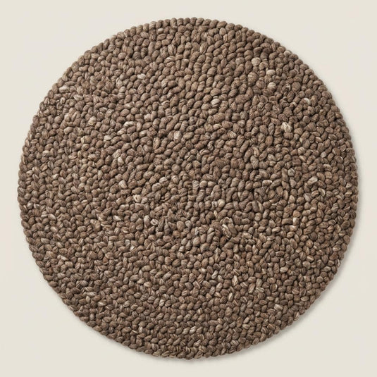 Translation missing: es.Neutral chunky wool area rug under accent chair with sunlight highlighting thick woven texture
