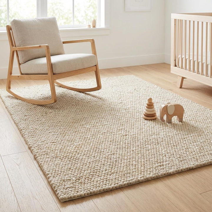 Translation missing: es.Large textured wool area rug in warm beige cream tone styled near fireplace and window light