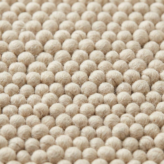 Translation missing: es.Handwoven textured wool area rug in neutral ivory tone perfect for organic modern living room decor