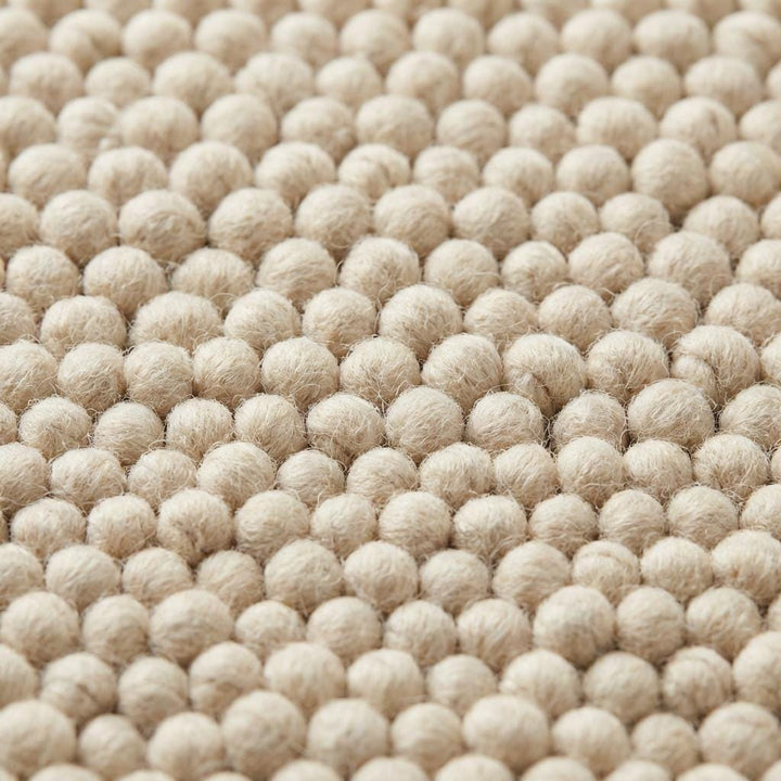 Translation missing: es.Handwoven textured wool area rug in neutral ivory tone perfect for organic modern living room decor