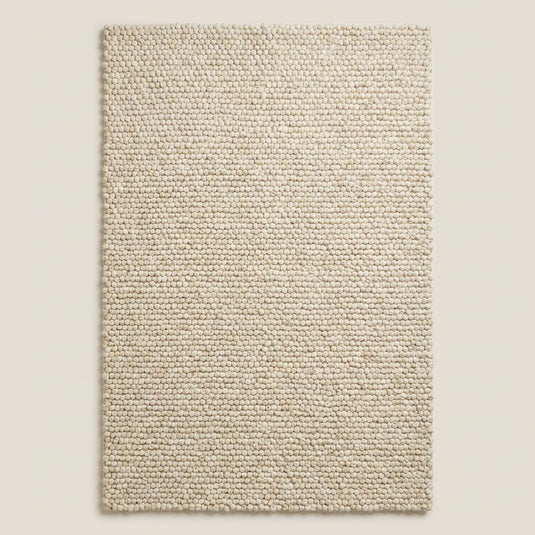 Translation missing: es.Handwoven chunky wool area rug with textured loop pile in soft neutral cream tone for Scandinavian minimalist interior design