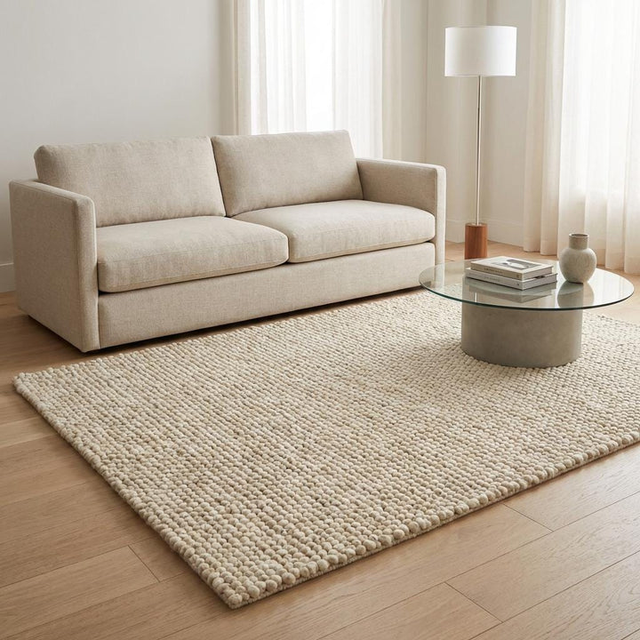 Translation missing: es.Cream handwoven wool rug with heavy textured weave placed on wooden floor, perfect modern neutral home accent