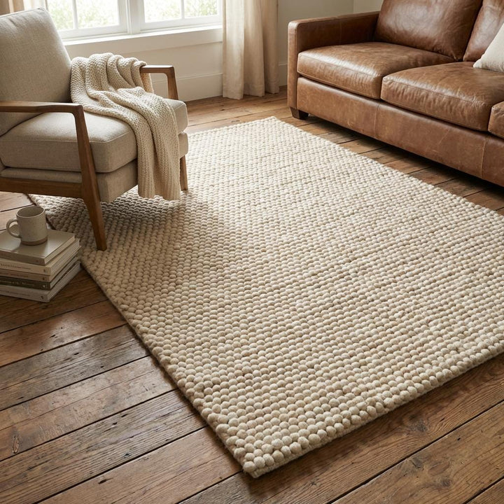 Translation missing: es.Textured cream wool floor rug with chunky woven design styled on hardwood floor for warm neutral decor aesthetic