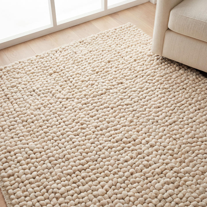 Translation missing: es.Handmade chunky wool rug in neutral beige with soft, textured, cozy design for boho and minimalist home decor