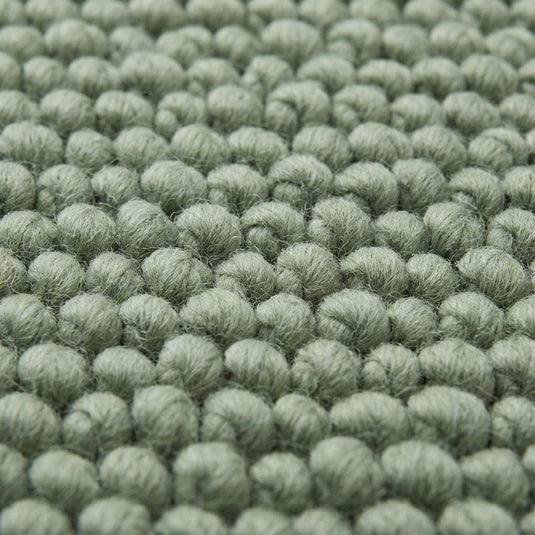 Translation missing: es.Chunky wool textured area rug in sage green with thick looped texture and cozy cushioned feel