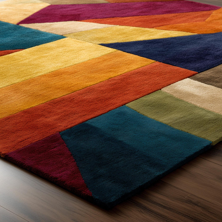 Translation missing: en.Colorful geometric area rug with triangle patchwork pattern in vibrant teal, navy, gold, and burgundy hues