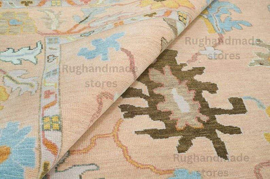 Translation missing: es.Hand-Knotted Oushak Wool Rug in light pink, dark brown, and purple with floral designs for living room decor