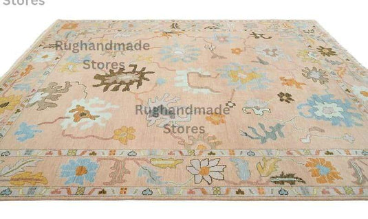 Translation missing: es.Hand-knotted Oushak wool rug with vintage floral design in light pink, dark brown, and purple accents for living room decor