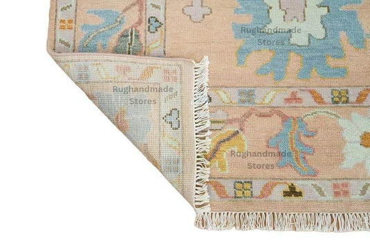 Translation missing: es.Hand-knotted Oushak wool rug with vintage floral design in light pink, dark brown, and purple accents for living room decor