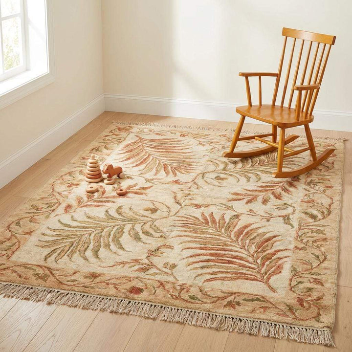 Translation missing: en.A transitional hand-knotted rug styled in a cozy home library next to a green velvet armchair and indoor plants