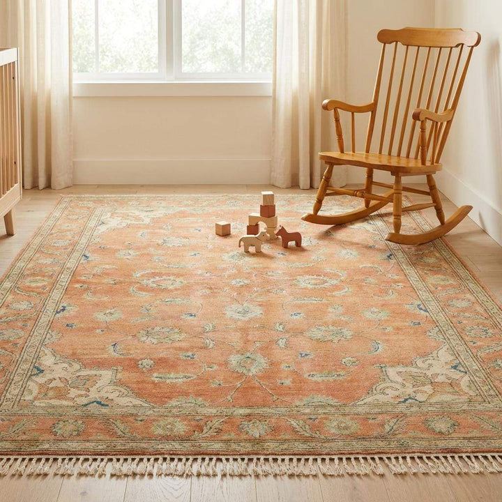 Translation missing: en.Wide shot of a large terracotta Oushak rug as the centerpiece of a sophisticated living room with natural lighting