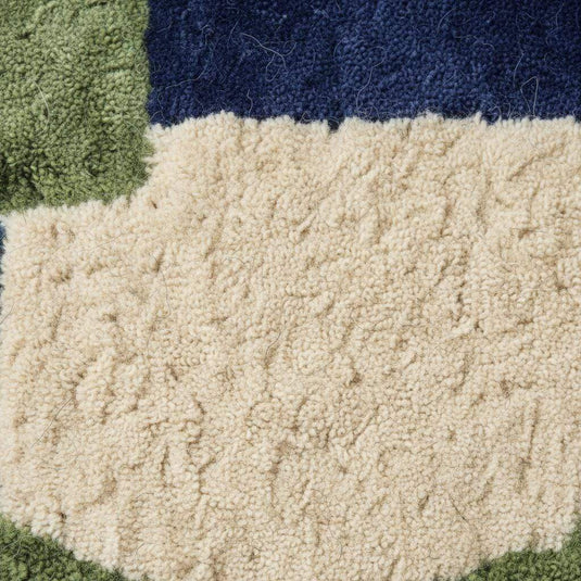 Translation missing: en.Hand tufted rug with bold blue and green geometric design, soft wool texture, and plush pile for mid-century modern decor