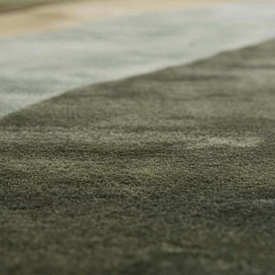 Translation missing: en.Hand tufted wool rug with abstract landscape design in earthy green tones for modern Scandinavian and Japandi interiors