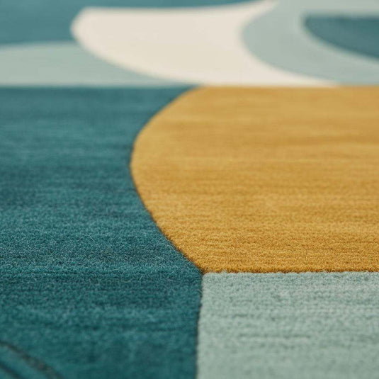 Translation missing: en.Close-up of tufted wool rug showing raised loops, soft wool texture, and vibrant geometric colors
