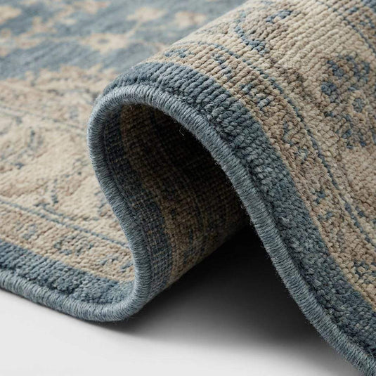 Translation missing: en.Close-up of hand knotted wool pile showing individual knots and soft natural fiber texture
