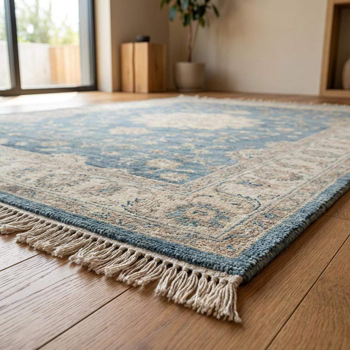 Translation missing: es.Living room styled with a blue hand knotted wool rug and neutral furniture