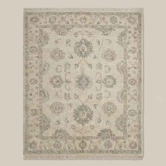 Translation missing: en.Neutral wool Oushak rug styled in living room with wooden floor and accent chair