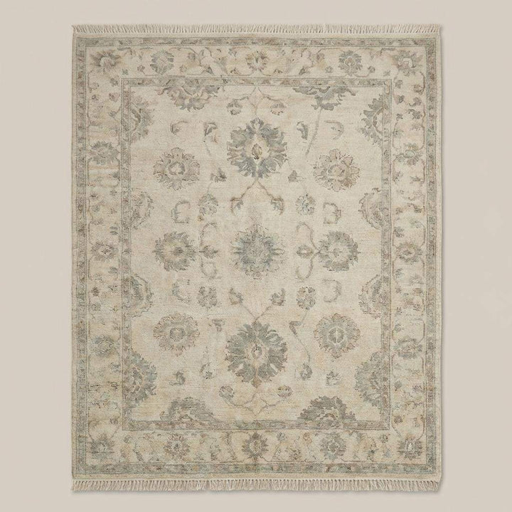 Translation missing: en.Neutral wool Oushak rug styled in living room with wooden floor and accent chair