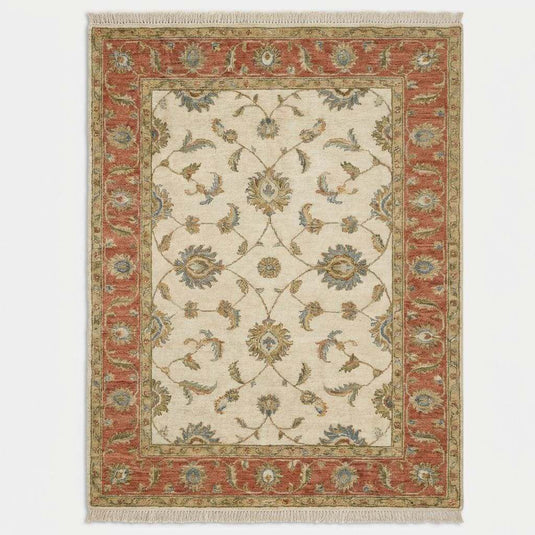 Translation missing: fr.Traditional vintage style Oushak rug with warm neutral tones styled beside accent chair and wood flooring