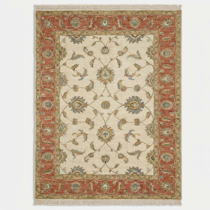 Translation missing: en.Traditional vintage style Oushak rug with warm neutral tones styled beside accent chair and wood flooring