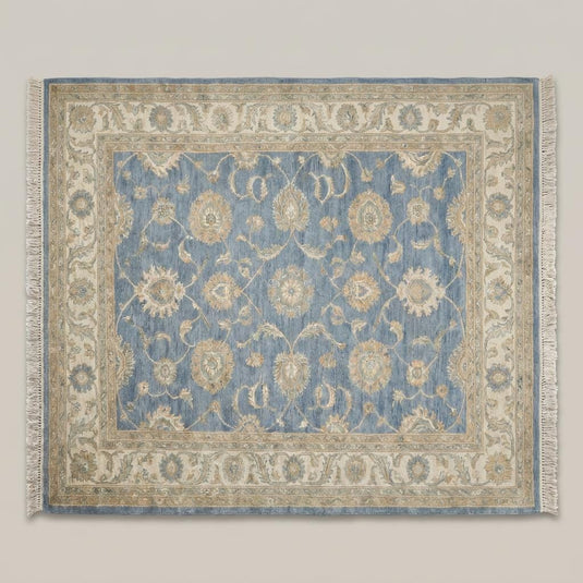 Translation missing: es.Blue and beige traditional wool rug styled beside a chair in a bright corner space __etsy:7982606684