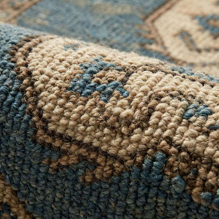 Translation missing: en.Close-up of hand knotted wool pile showing individual knots, natural fiber texture, and subtle vintage abrash color variation