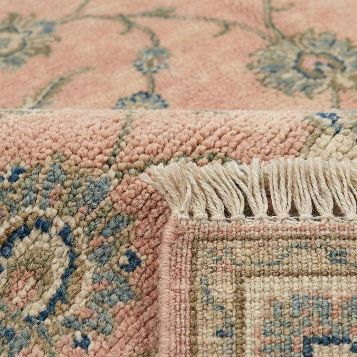 Translation missing: en.Close up of hand knotted wool pile showing individual knots and soft floral vine pattern