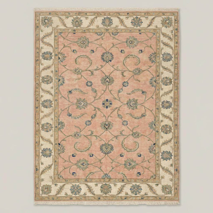 Translation missing: en.Intricate Turkish floral motifs in sage green and blue on a pastel pink wool rug