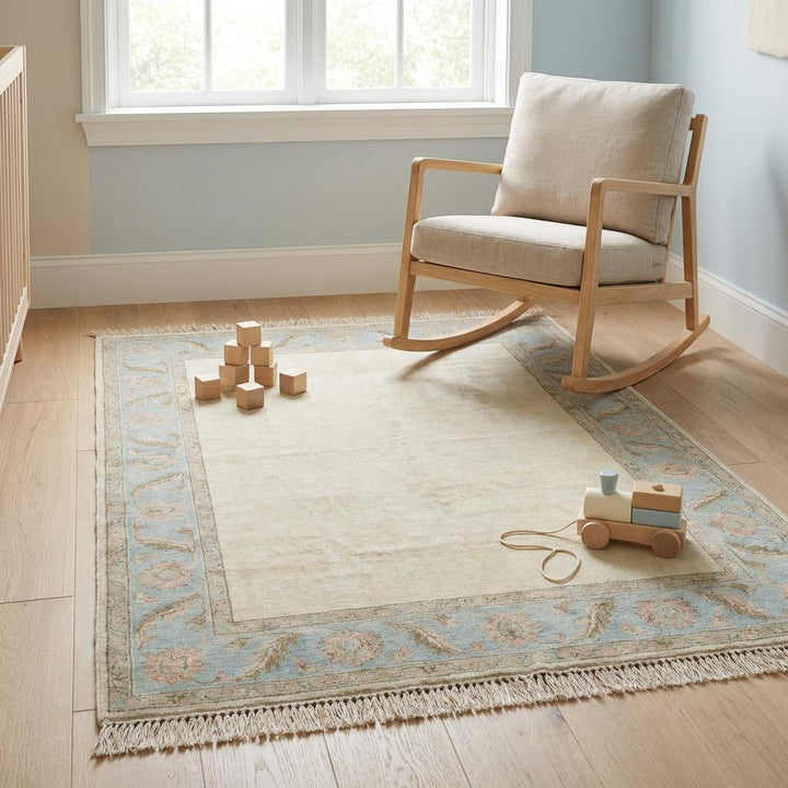 Translation missing: es.Rectangular handmade wool Persian style rug in calming ivory, sky blue, and dusty rose tones