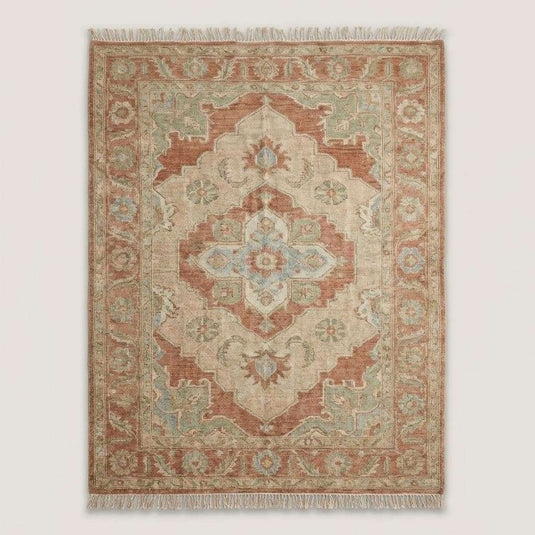 Translation missing: es.Terracotta and sage wool area rug styled in a neutral living room with an upholstered chair, showing scale and decor fit