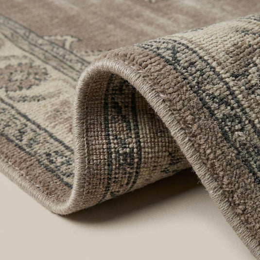 Translation missing: en.Close up of hand knotted wool pile showing tight weave structure and distressed vintage finish