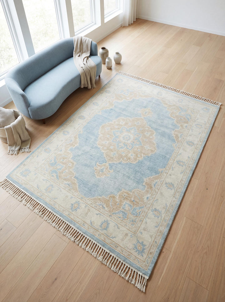 Translation missing: es.Hand knotted Oushak rug with blue wool medallion design in neutral living room setting