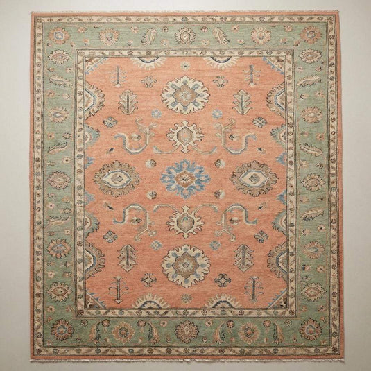 Translation missing: es.Detailed view of floral medallion and vine motifs on a hand knotted wool rug with Persian-inspired Oushak design