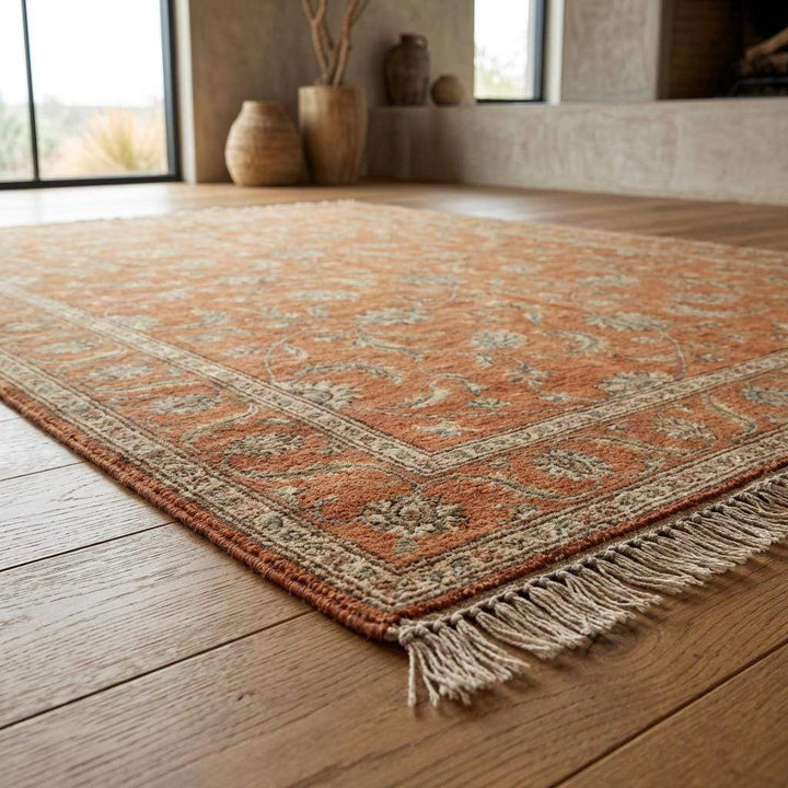 Translation missing: es.Detail of the hand-finished fringe and edge of a terracotta hand-knotted rug, highlighting the authentic craftsmanship and lack of synthetic backing