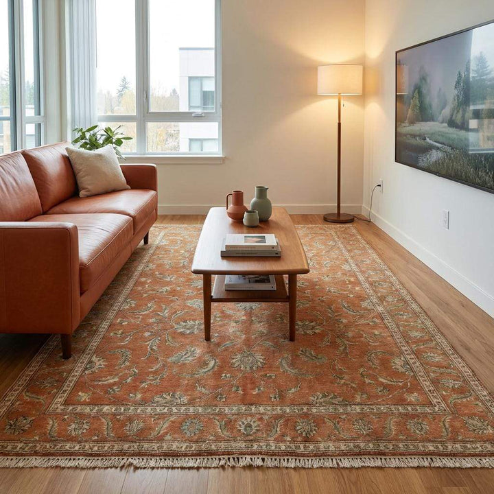 Translation missing: es.A warm-toned Oushak rug in a living room setting, demonstrating how the rust and terracotta colors ground a space with natural light