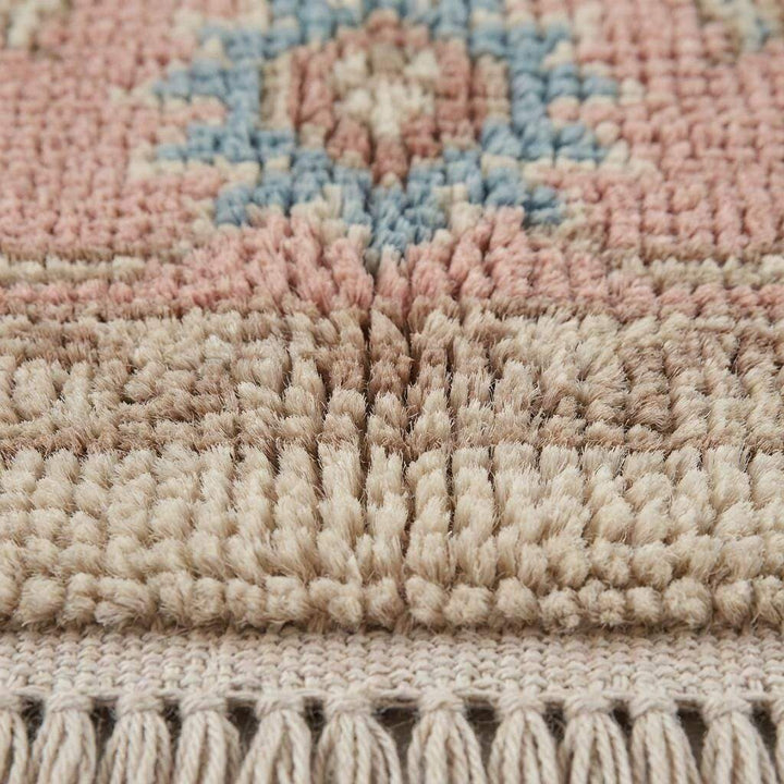 Translation missing: en.Close-up of hand knotted wool pile showing individual knots, soft wool fibers, and artisanal texture