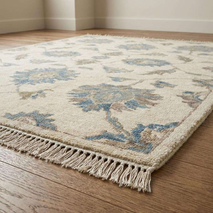 Translation missing: es.Artisan made Oushak style rug featuring soft ivory background and distressed blue floral design