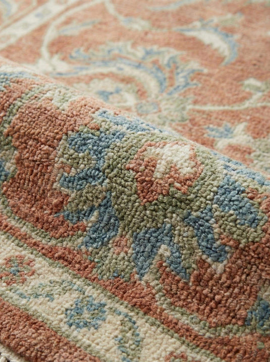 Translation missing: es.Close up of hand knotted wool rug showing dense knots, natural wool fibers, and low pile texture