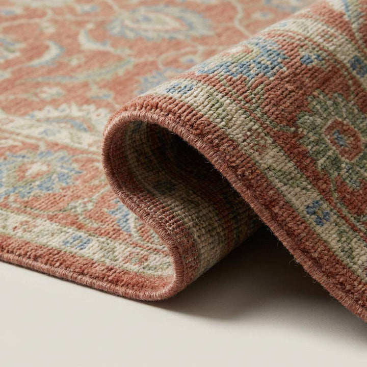 Translation missing: en.Close up of hand knotted wool rug showing dense knots, natural wool fibers, and low pile texture