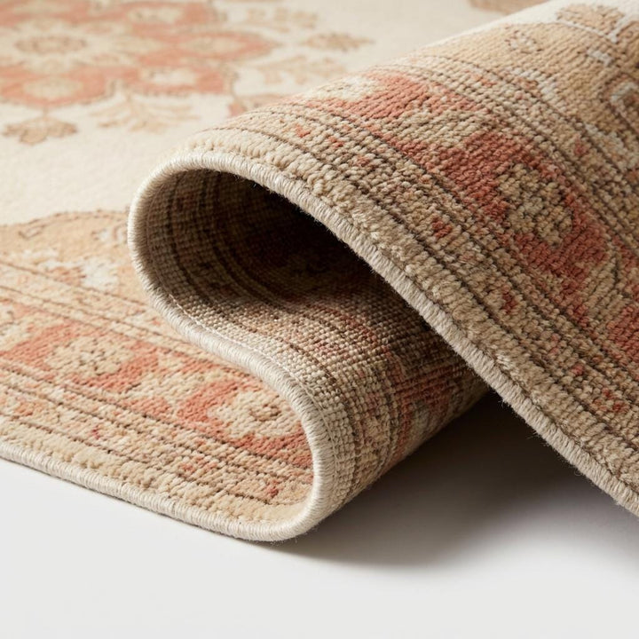 Translation missing: en.Hand knotted Oushak wool rug with ivory and terracotta floral medallion in vintage style living room setting