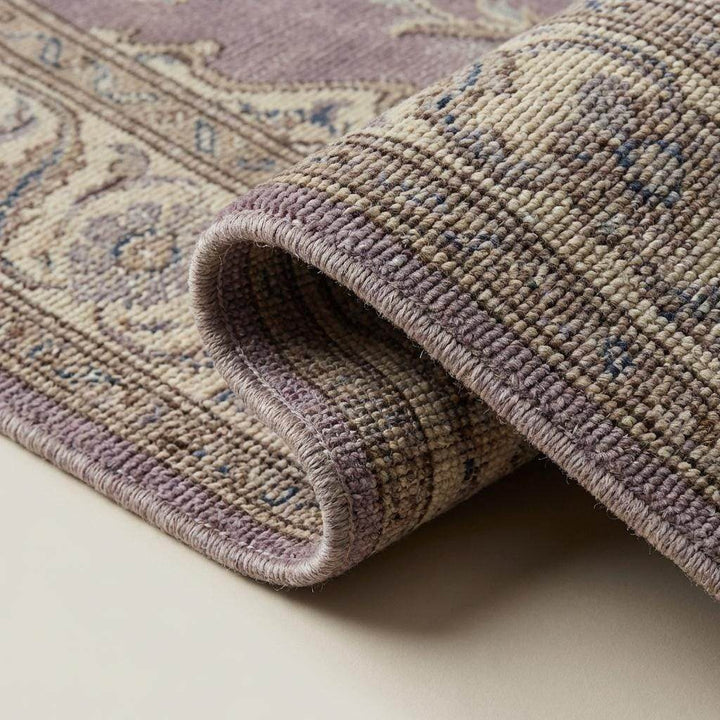 Translation missing: en.Close-up of hand knotted wool rug showing dense knot structure, natural wool fibers, and detailed craftsmanship