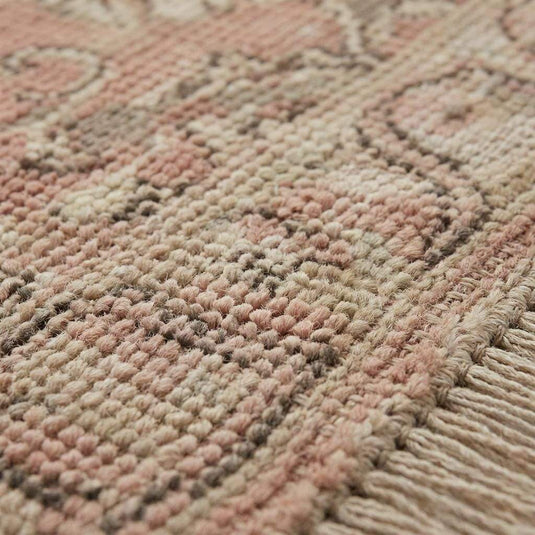 Translation missing: en.Close up of hand-knotted wool pile showing individual knots and soft texture, distinguishing it from machine-made or tufted rugs