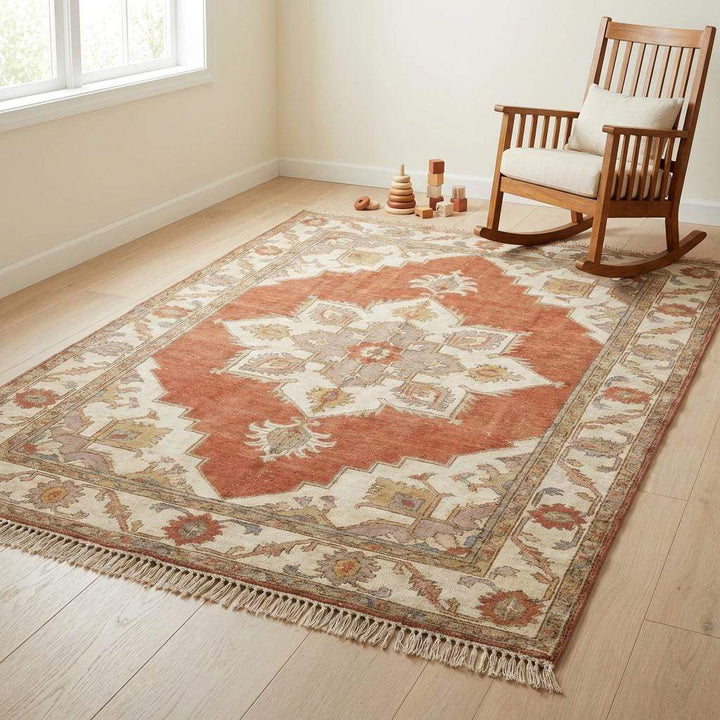Translation missing: en.Lifestyle setting showing how the warm rust and ivory tones of this handmade rug complement neutral wall colors and wood furniture