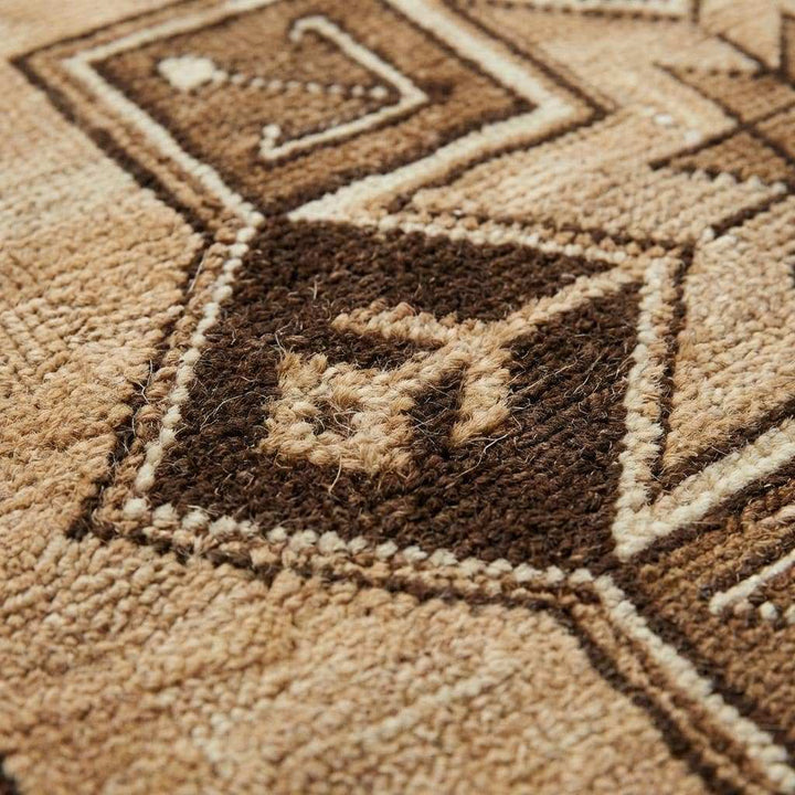Translation missing: en.Close-up of hand knotted wool rug showing dense knot structure and natural wool fibers