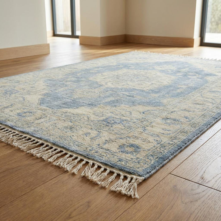 Translation missing: en.Artisan handmade wool area rug with floral border and muted vintage blue tones